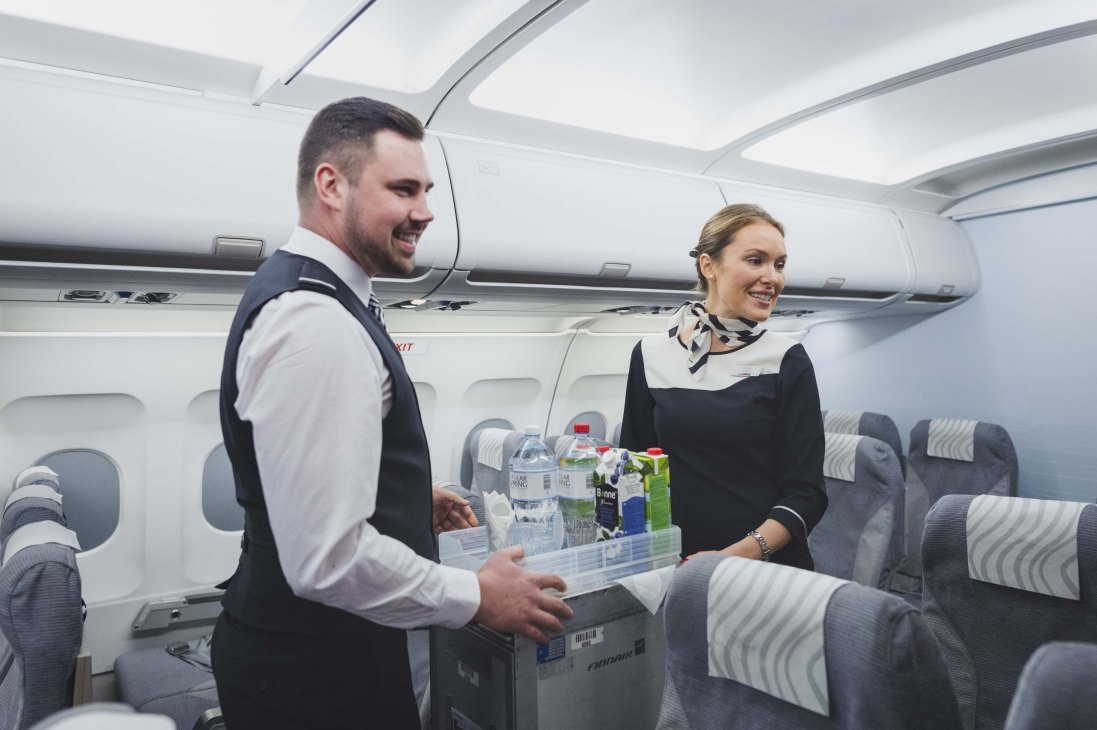 Finnair flight attendants demonstrate beverage service on an aircraft during training at the Flight Academy.