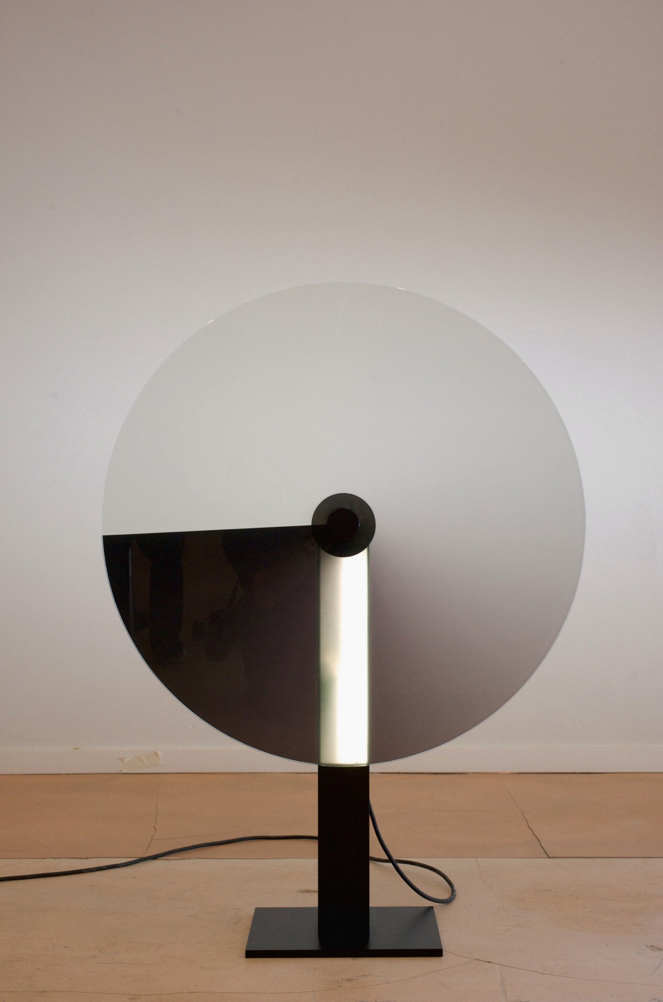 Gradient Lamp by Camille Blin: a minimalist table lamp with a large circular diffuser and dark base.