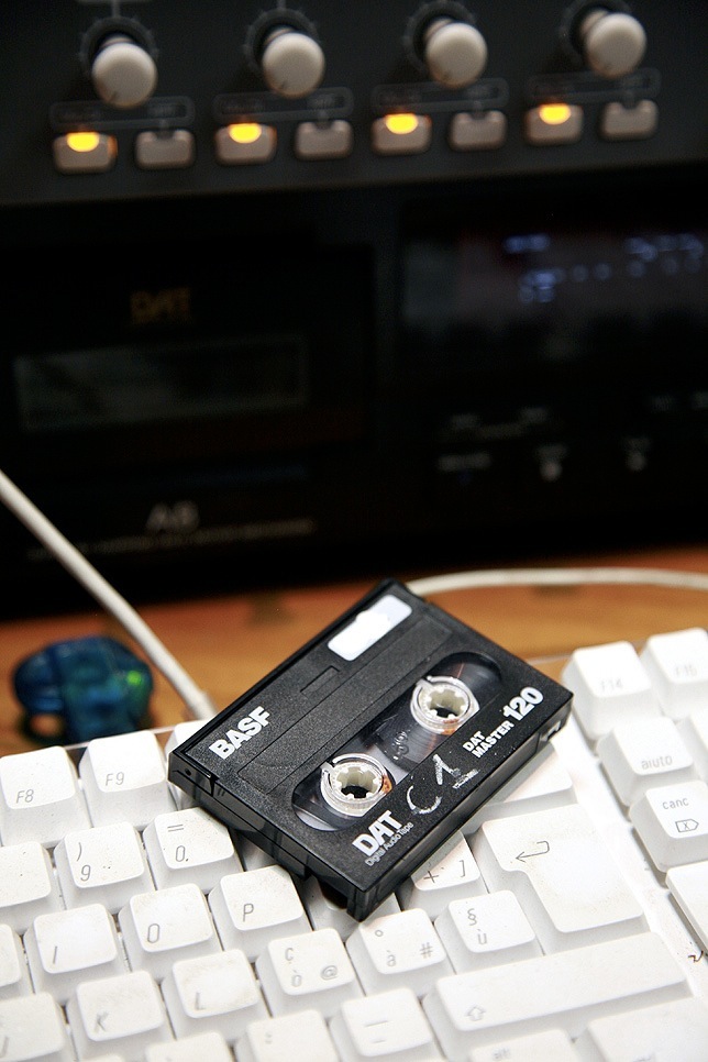 A BASF digital audio tape cassette rests on a computer keyboard in a recording studio.