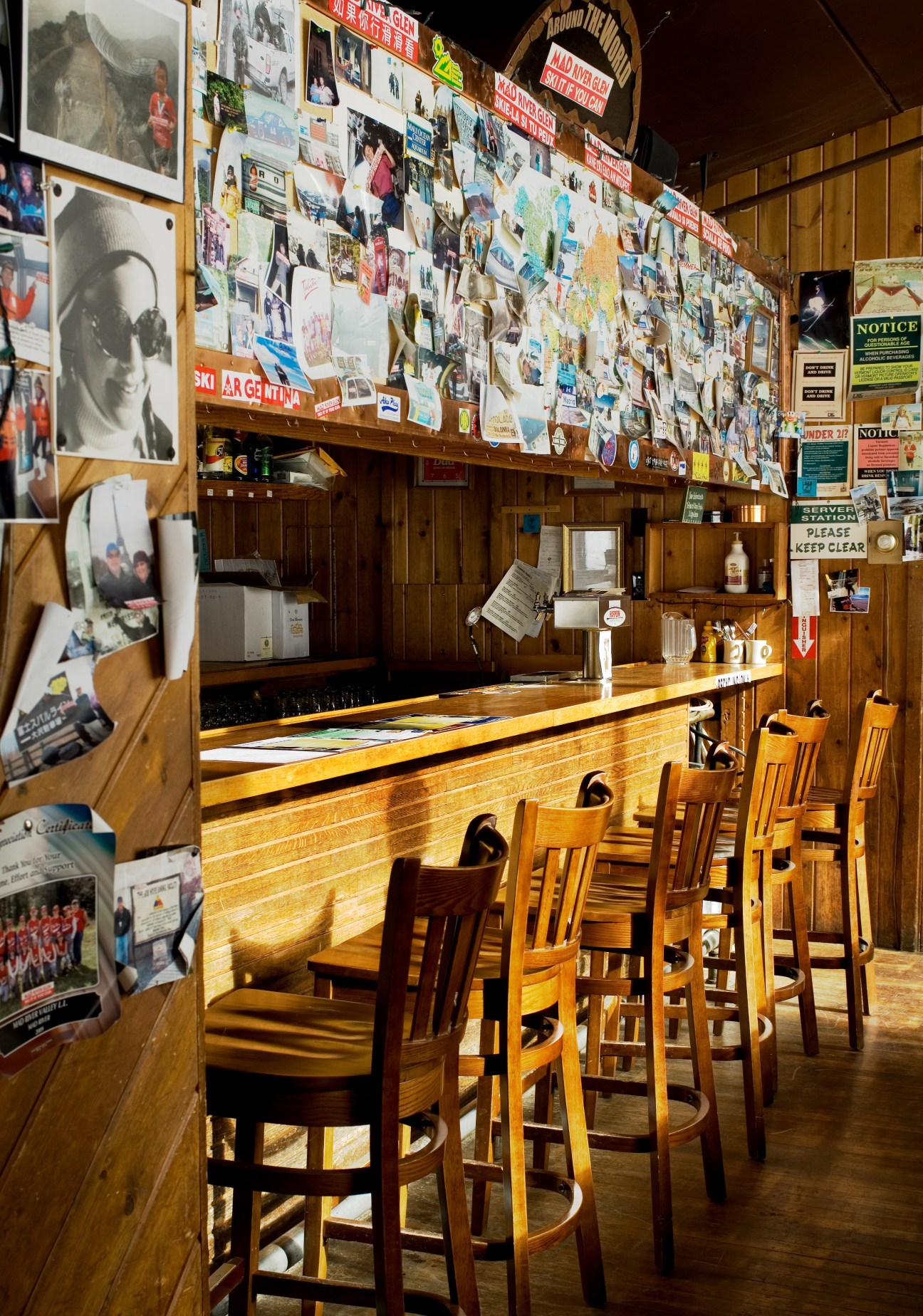 Interior of General Stark's Pub with wooden bar, bar stools, and walls covered with photographs and memorabilia.