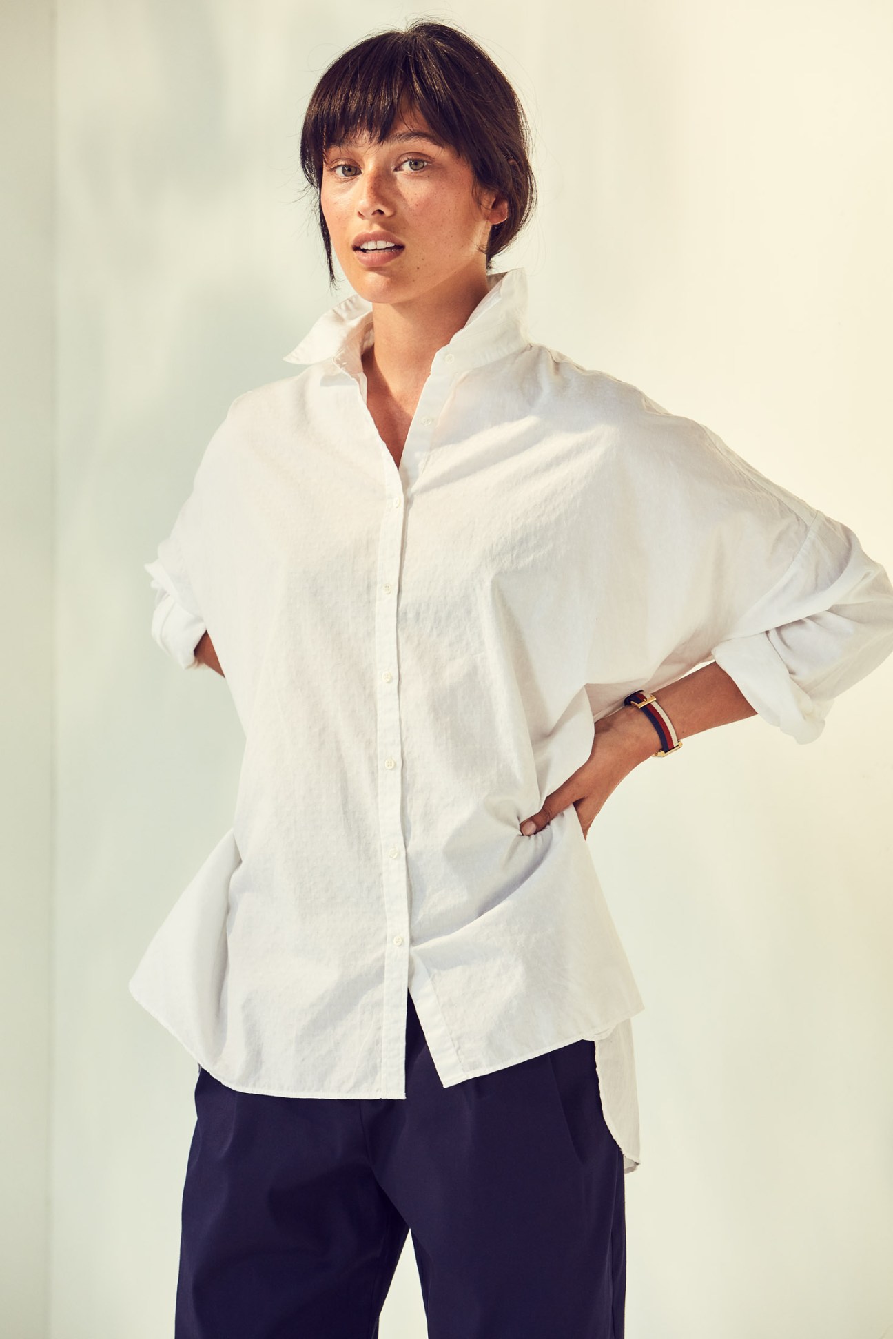 Model wearing white Massimo Alba shirt, Roberto Collina trousers, and Gucci watch