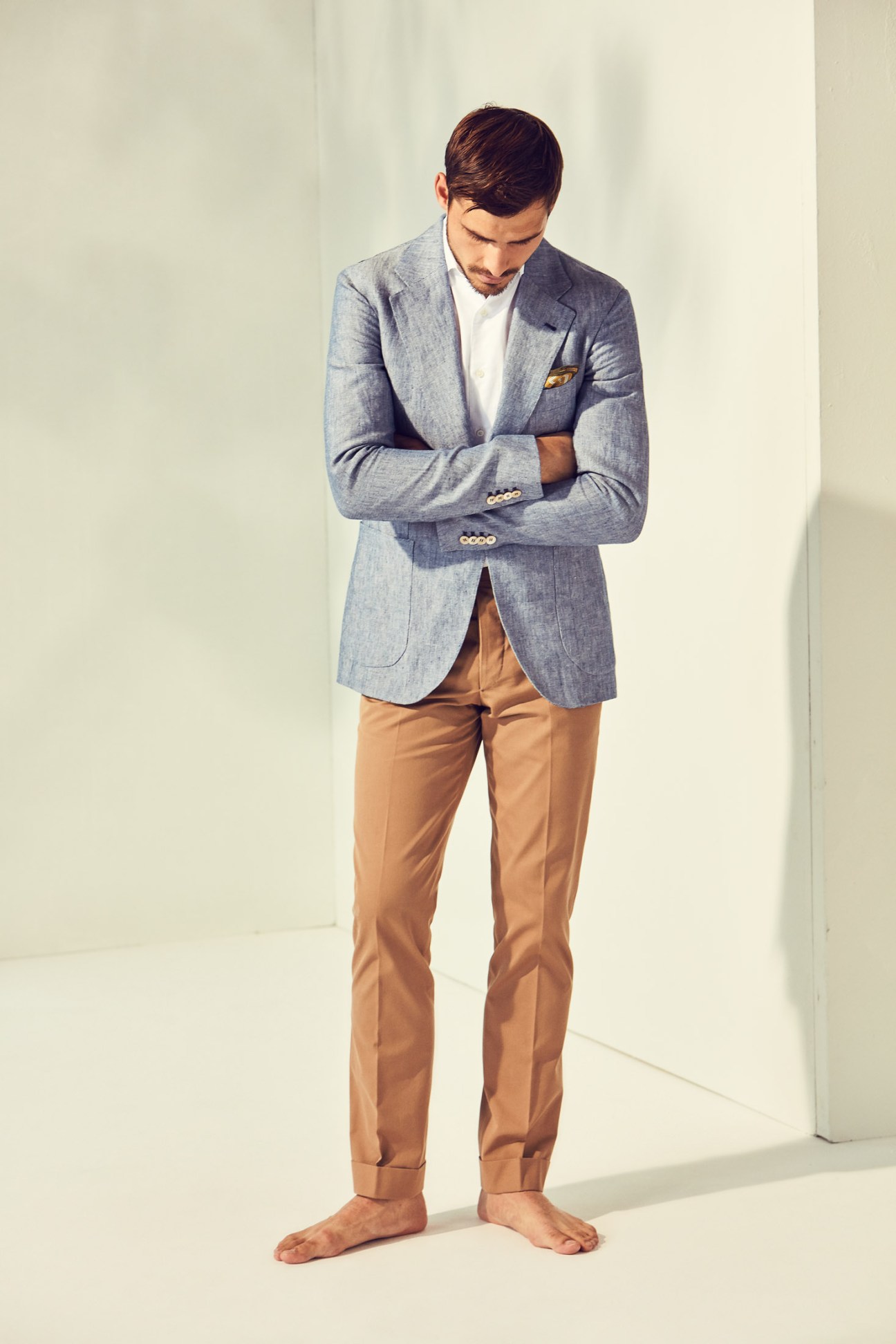 Male model wearing Orazio Luciano jacket and trousers with Ships shirt and Drake's pocket square.