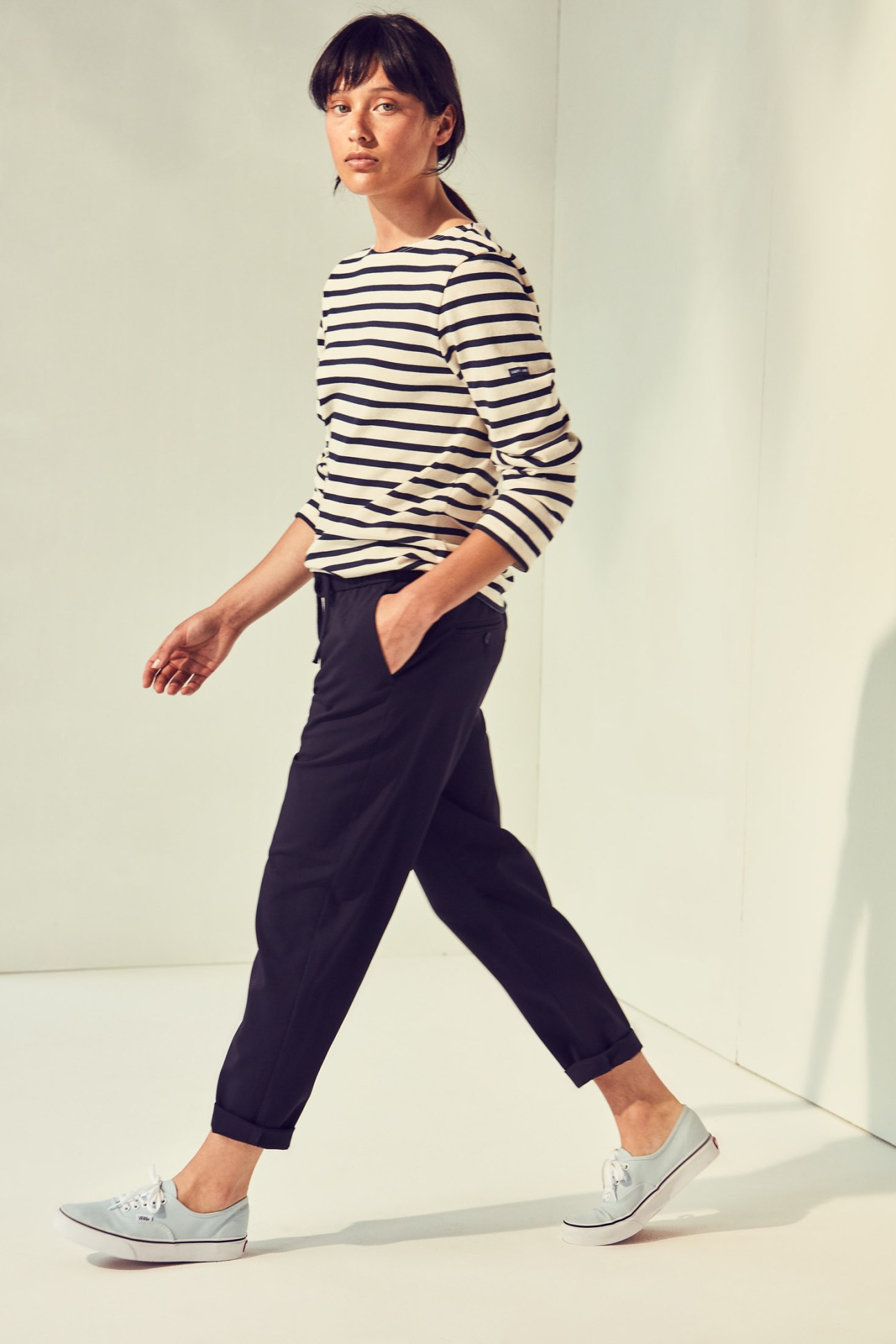 Model wearing Saint James striped long-sleeve t-shirt, Barena Venezia trousers, and Vans trainers