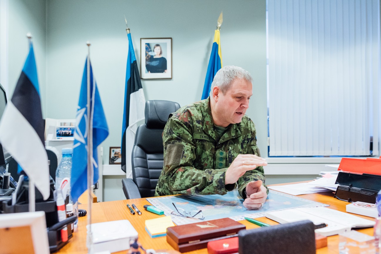 Lieutenant General Riho Terras in military uniform speaking at his desk with Estonian and NATO flags behind him.