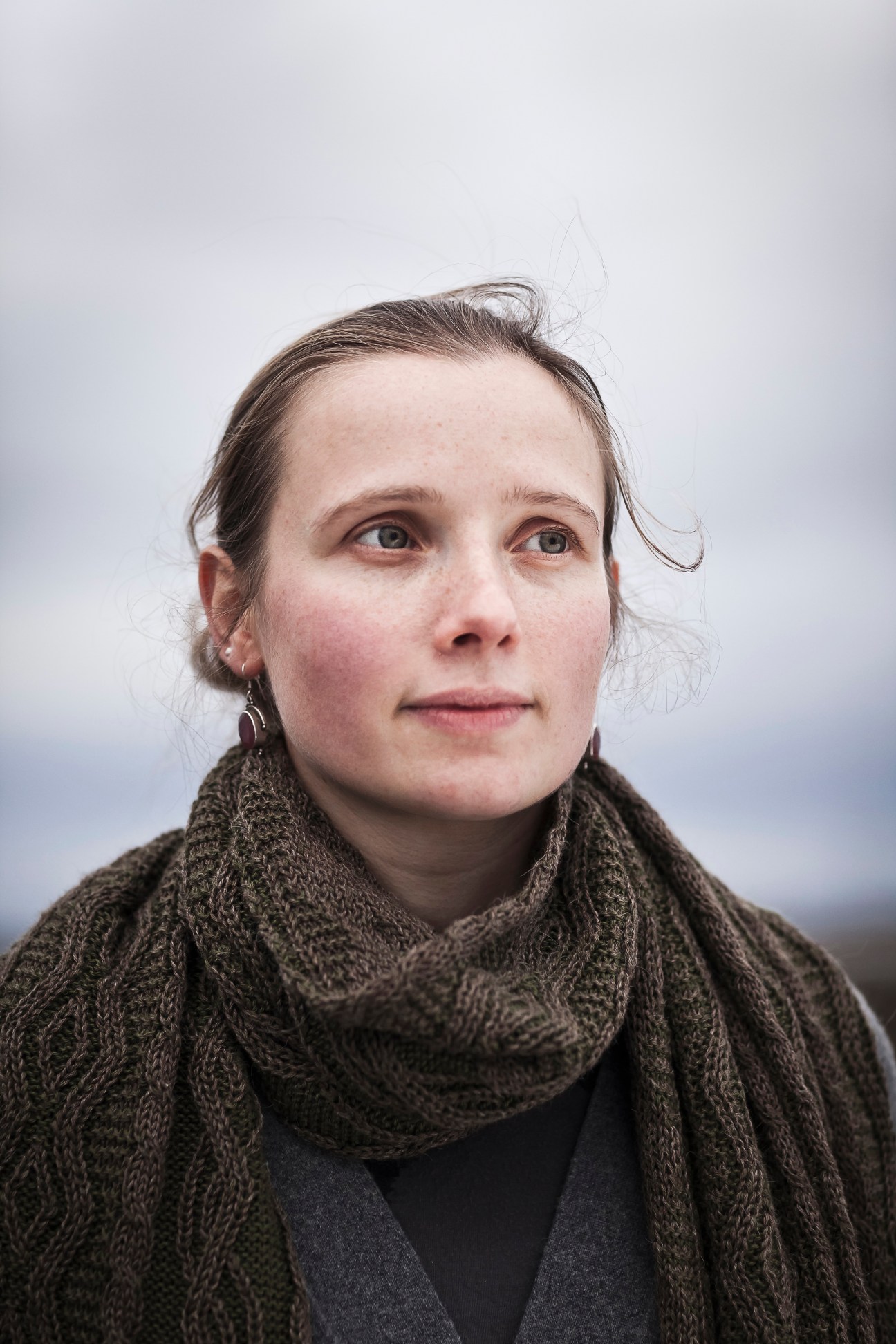 Portrait of Alice Gollner, design engineer at Inis Meáin, wearing a dark knit sweater and scarf