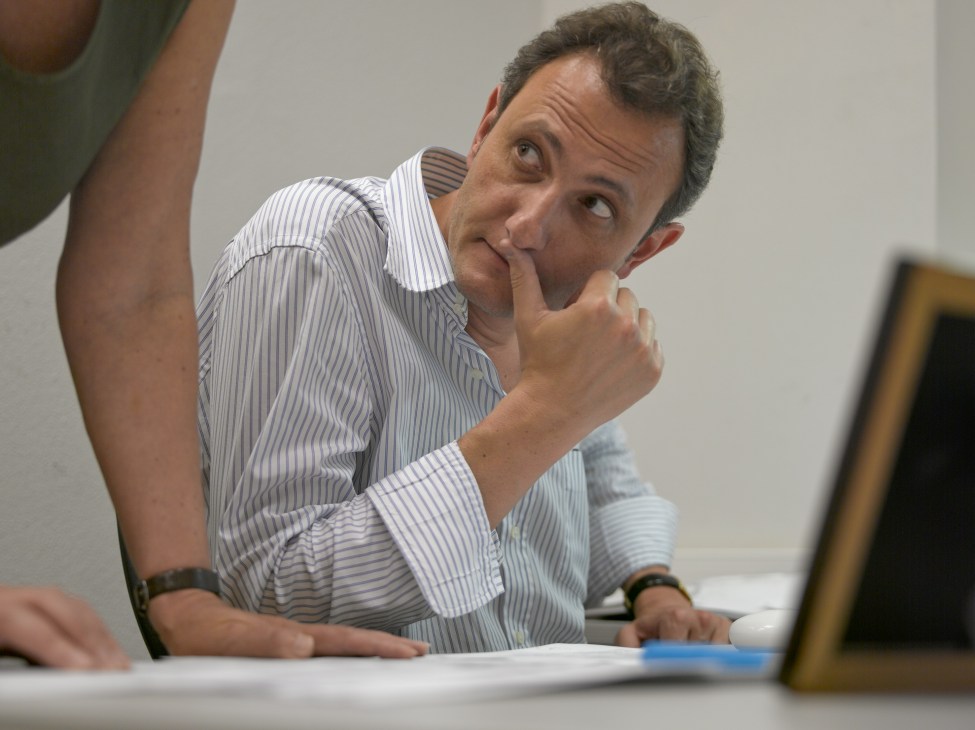 Andrey Kolesnikov, co-deputy editor of The New Times, sitting at a desk in a thoughtful pose.