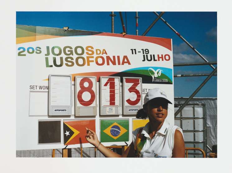 Beach volleyball scoreboard displaying match score with national flags of participating countries including Brazil and Angola.
