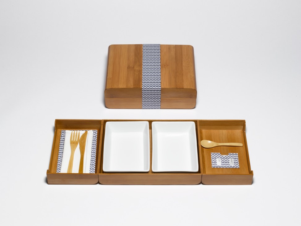 Bamboo inflight catering box by India Mahdavi with wooden cutlery, porcelain trays and patterned fabric accents.
