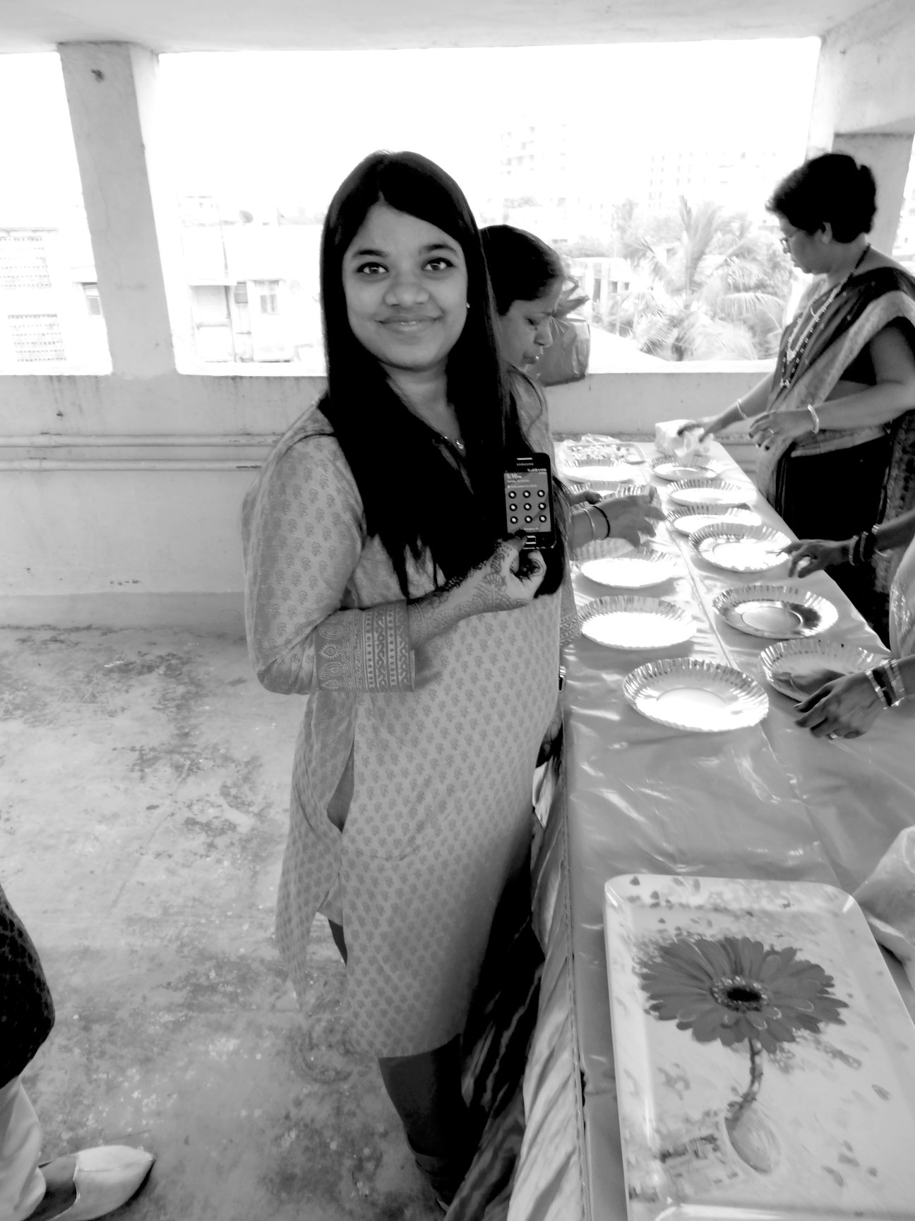 Jui Gangan, co-founder of Cycle Chalao, smiles at the camera while holding a device at an event in India.