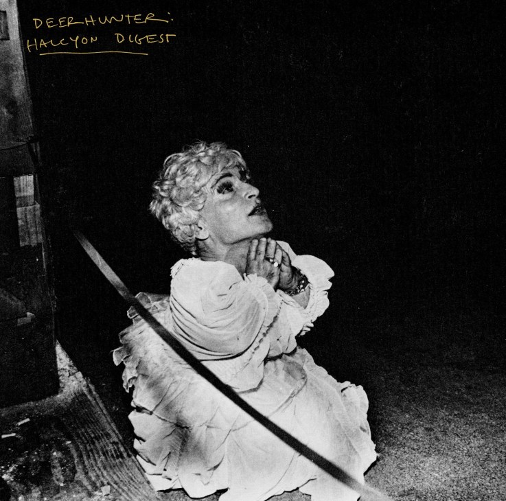 Black and white photograph of a woman in classical dress holding a spear, with handwritten text reading 'DEER-HUNTER HALCYON DIGEST' at top.