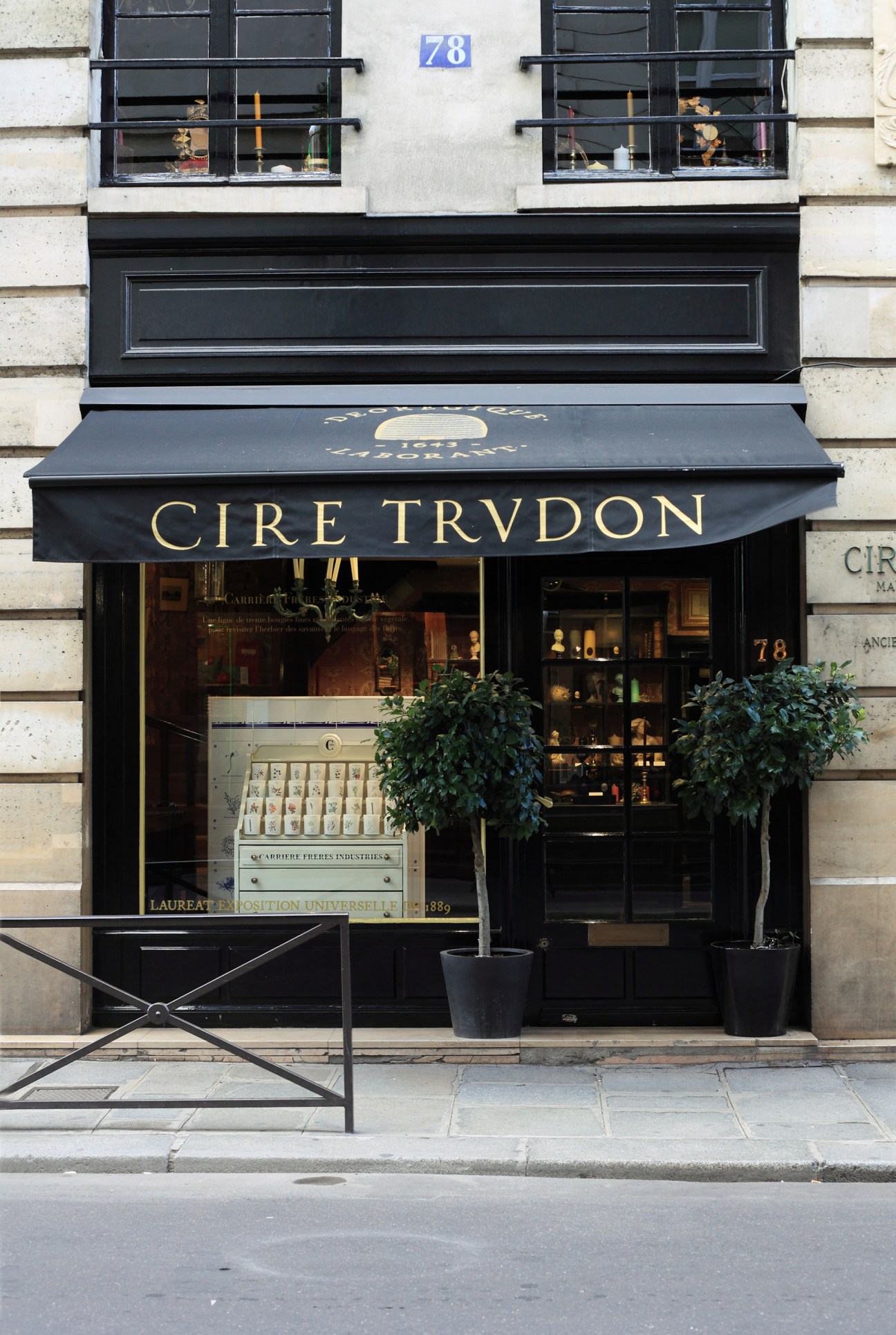 Cire Trudon's Paris storefront with black awning and gold lettering at street level