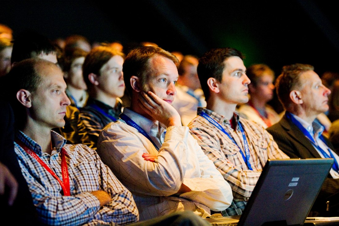Attendees at the CCDCOE's 2010 conference on Cyber Conflict watch a presentation intently.