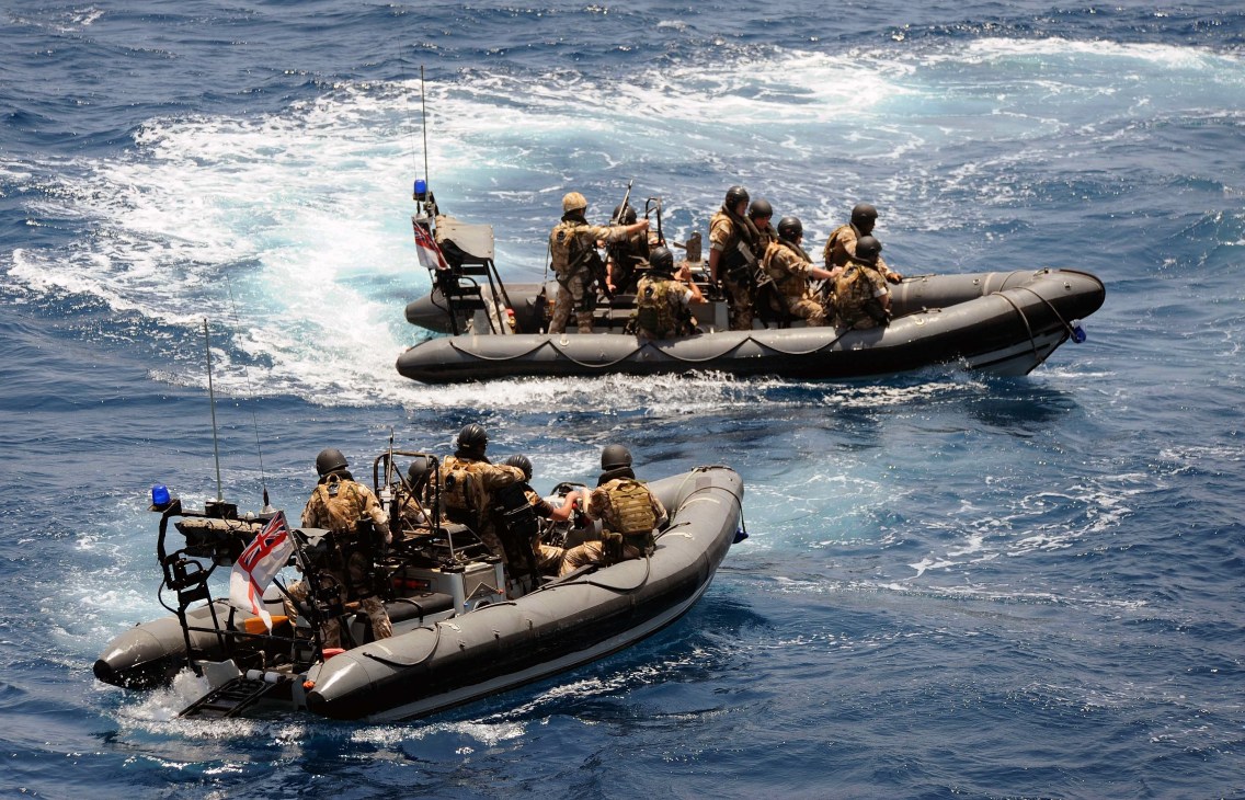 NATO naval personnel in inflatable boats conduct anti-piracy patrol operations in the Horn of Africa.