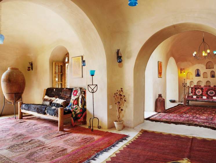 Interior of Rahim Walizada's design centre in Kabul featuring traditional Afghan rugs and furnishings.