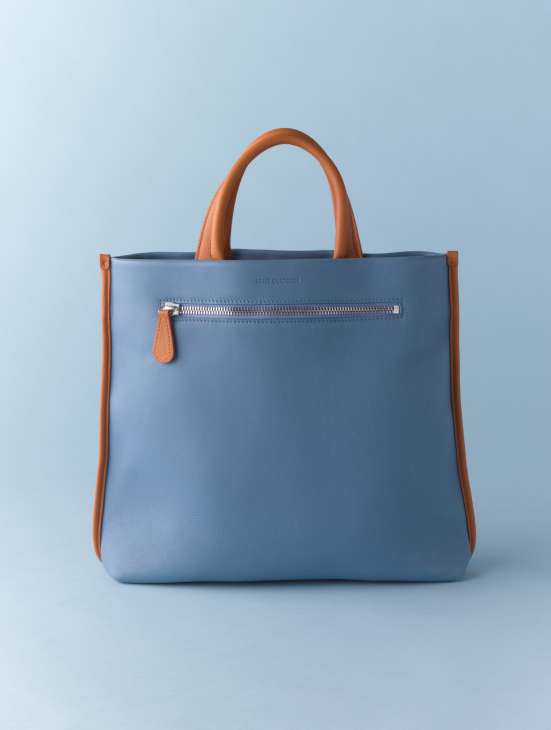 Louis Quatorze leather handbag in blue with tan handles and zipper pocket.