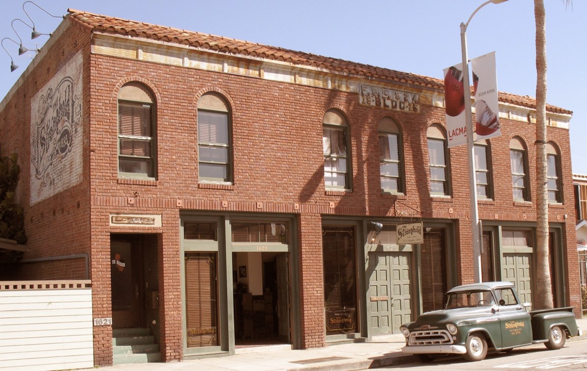 The Stronghold store on Venice's Abbot Kinney Boulevard in Los Angeles, a red brick building with vintage truck parked outside.