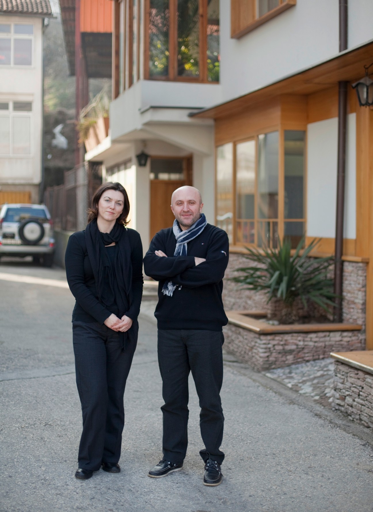 Jasna Mujkic and Salih Teskeredzic standing in a Konjic street with wooden buildings
