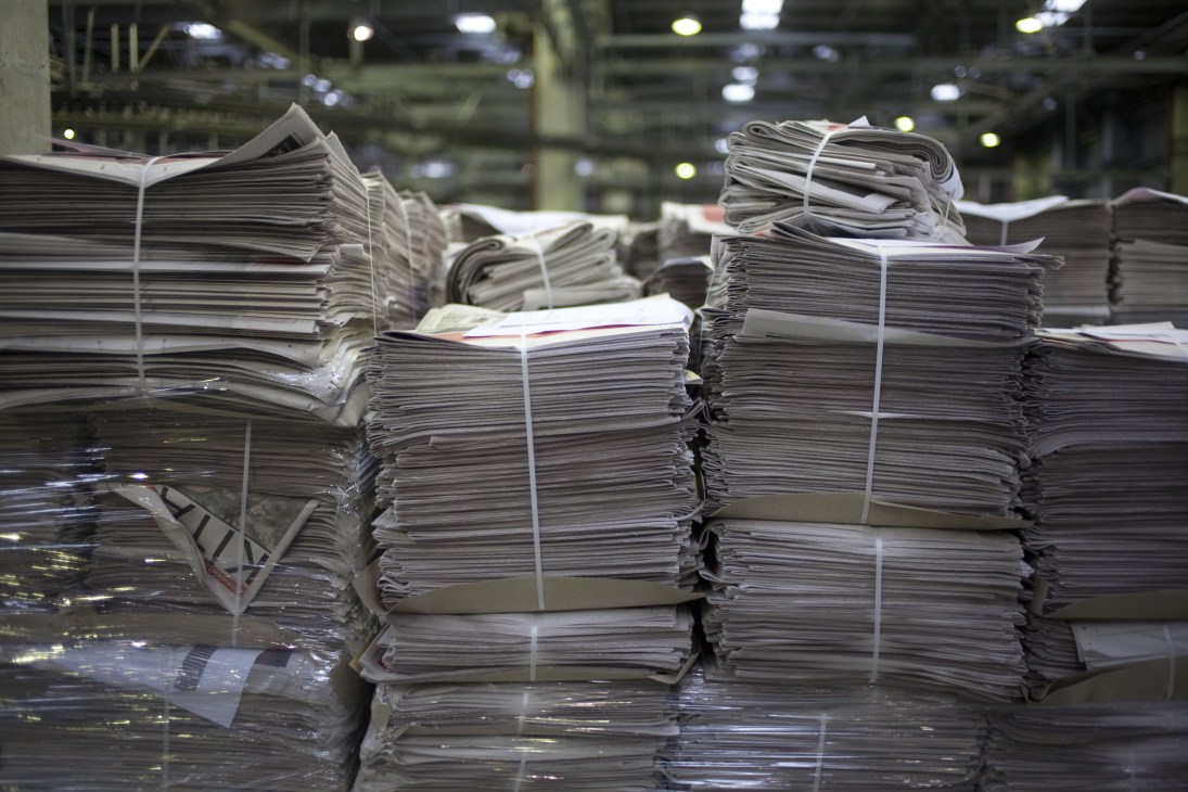 Stacks of bundled newspapers wrapped in plastic at Dogan's printing press facility.
