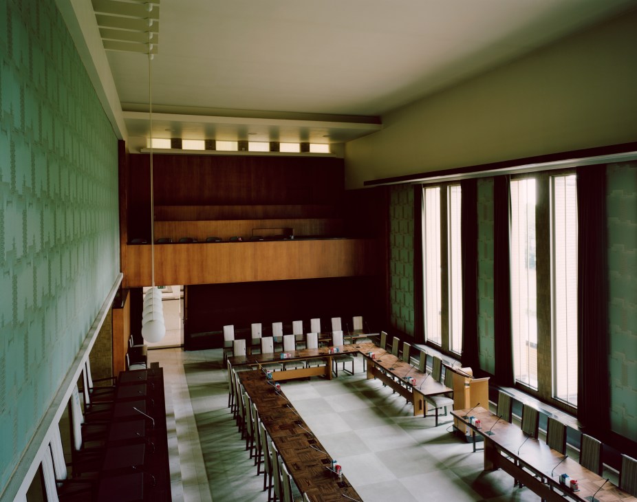 The council chamber at Hilversum's Dudok-designed town hall with modernist furnishings and striped floor