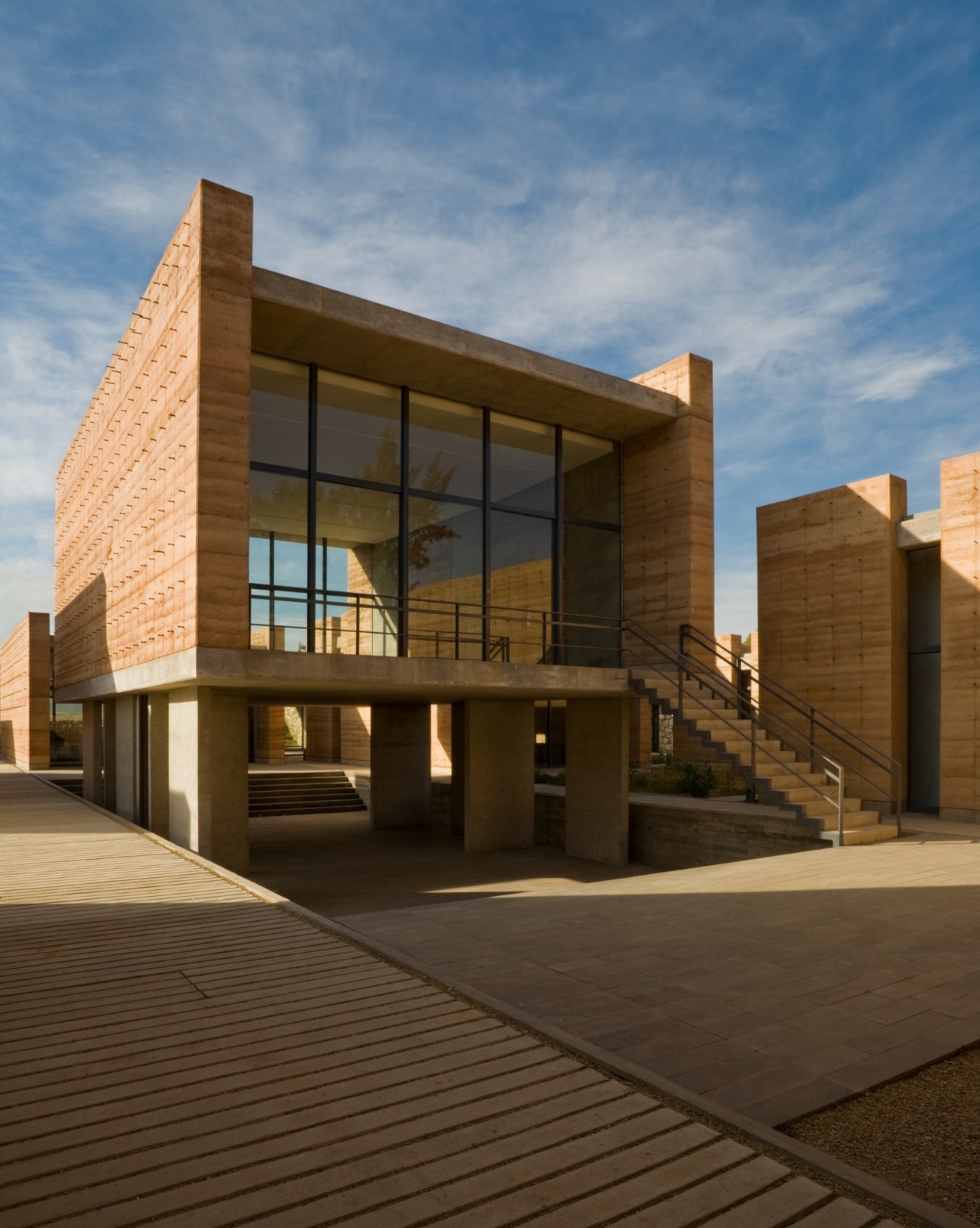 Exterior view of the Oaxaca School of Fine Arts showing rammed earth and concrete modular architecture.