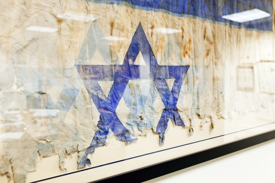 Israeli flag Star of David symbol displayed on weathered textured surface in diplomatic setting.