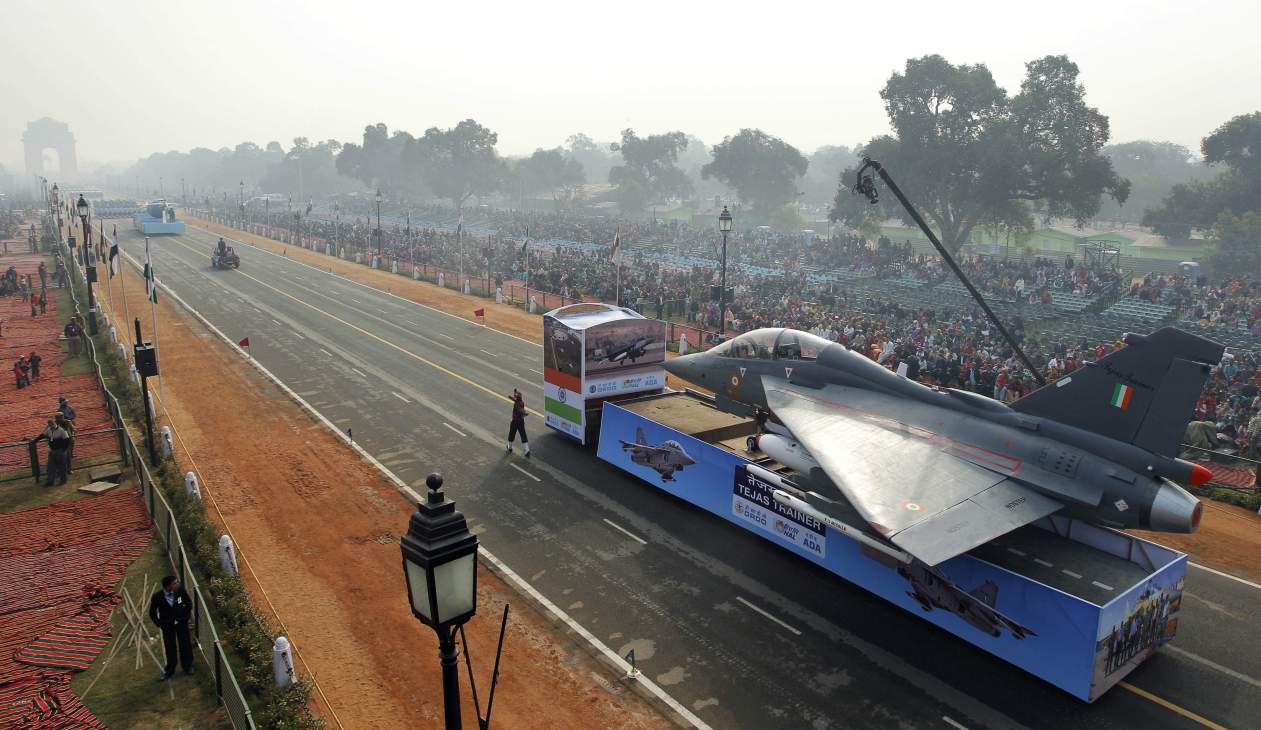 India's Tejas fighter jet on display during a military parade with crowds lining the street.