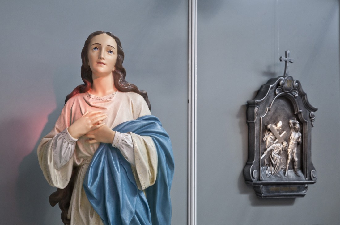 Colorful Virgin Mary statue displayed at SacroExpo religious trade fair in Poland.