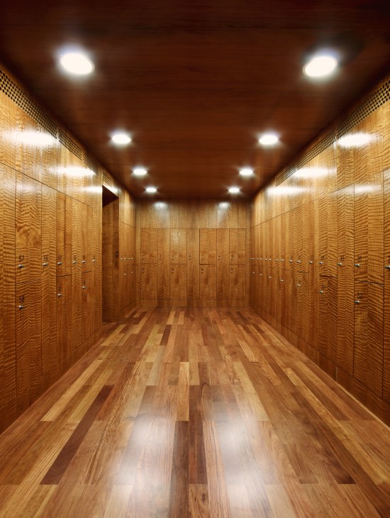 Interior of Samedan spa changing room with wooden lockers and parquet flooring.