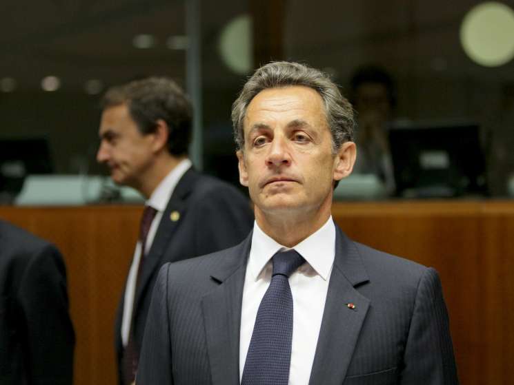 Nicolas Sarkozy in formal business attire at an official government meeting or EU summit.