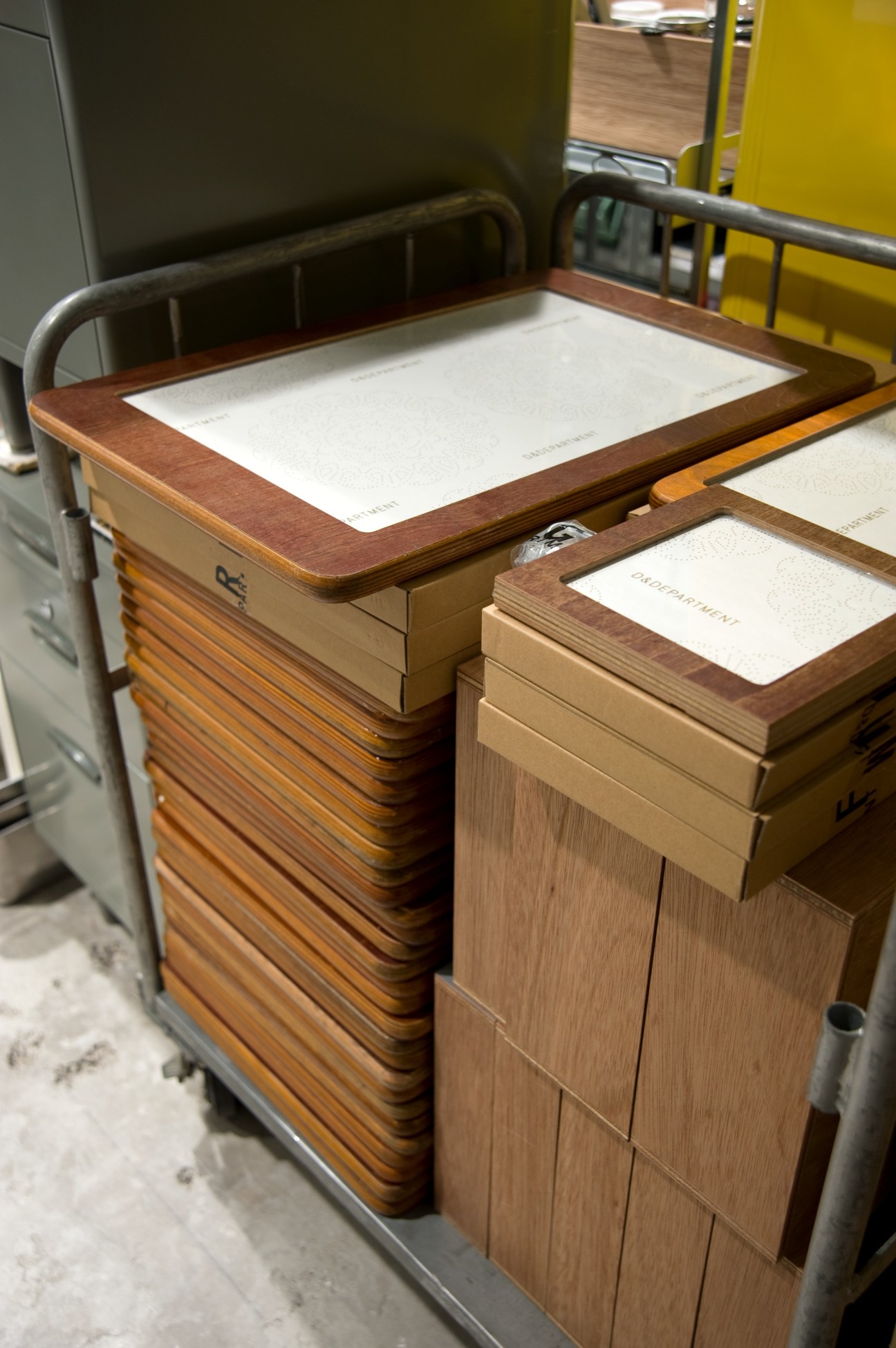 Wooden photo frames made from repurposed school desktops displayed on vintage furniture.