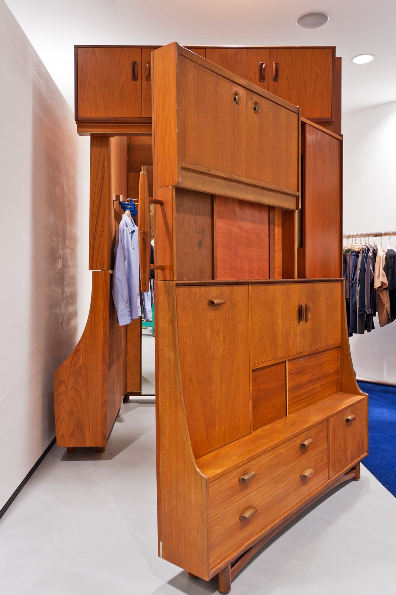 Michael Samuels' antique wooden cupboards repurposed as fitting rooms in Dover Street Market Ginza.