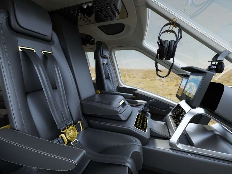 Interior of Quest Helicopters dual-rotor helicopter showing luxury reclining seats with gold accents and refreshment cabinetry.
