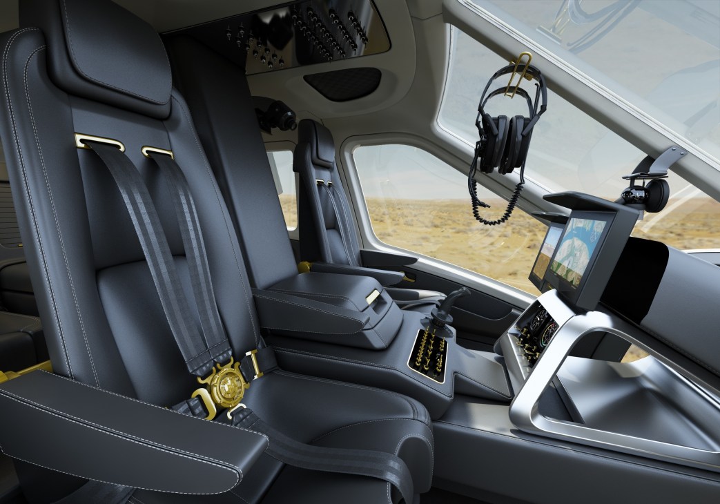 Interior of Quest Helicopters dual-rotor helicopter showing luxury reclining seats with gold accents and refreshment cabinetry.