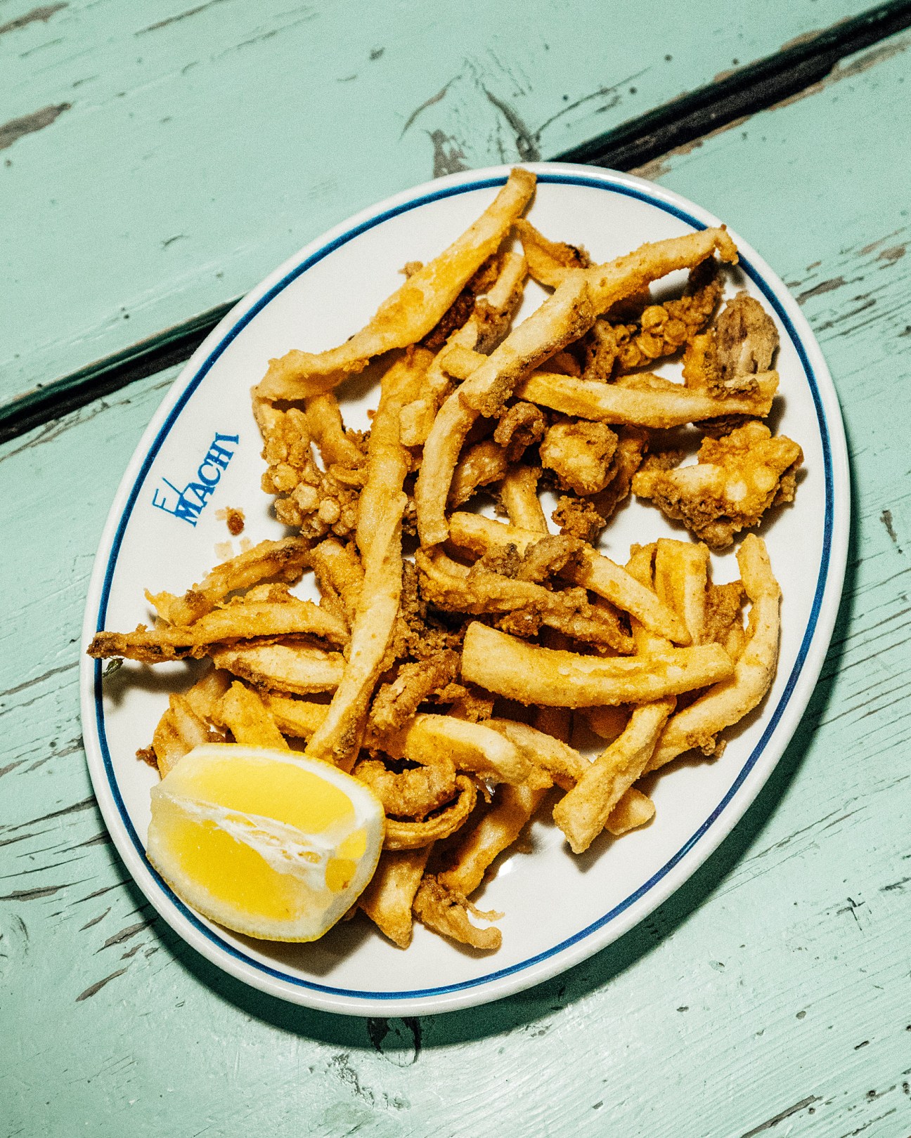 Fried squid rabas and fries with lemon on El Machi plate