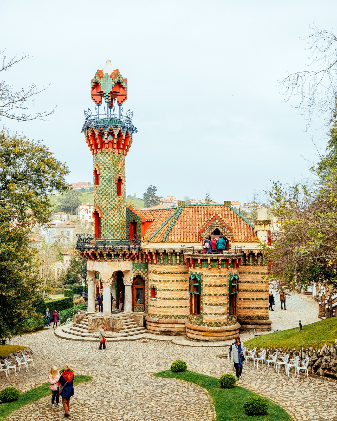 Gaudí's El Capricho, a colorful modernist building with ornate red and green tiled tower in Comillas, Cantabria.