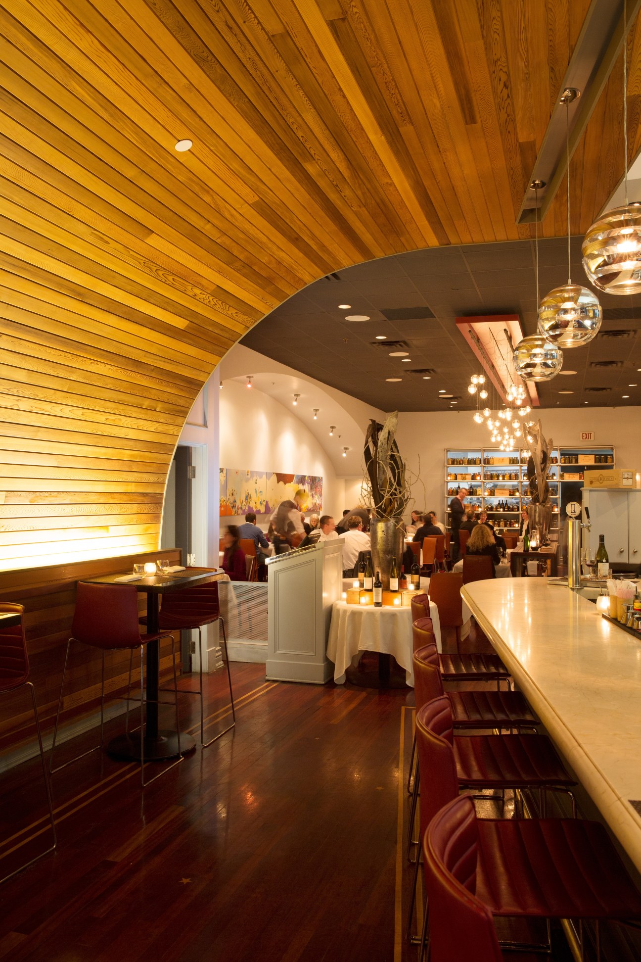 Splendido restaurant interior featuring a high wooden slatted ceiling with pendant lights and bar seating.