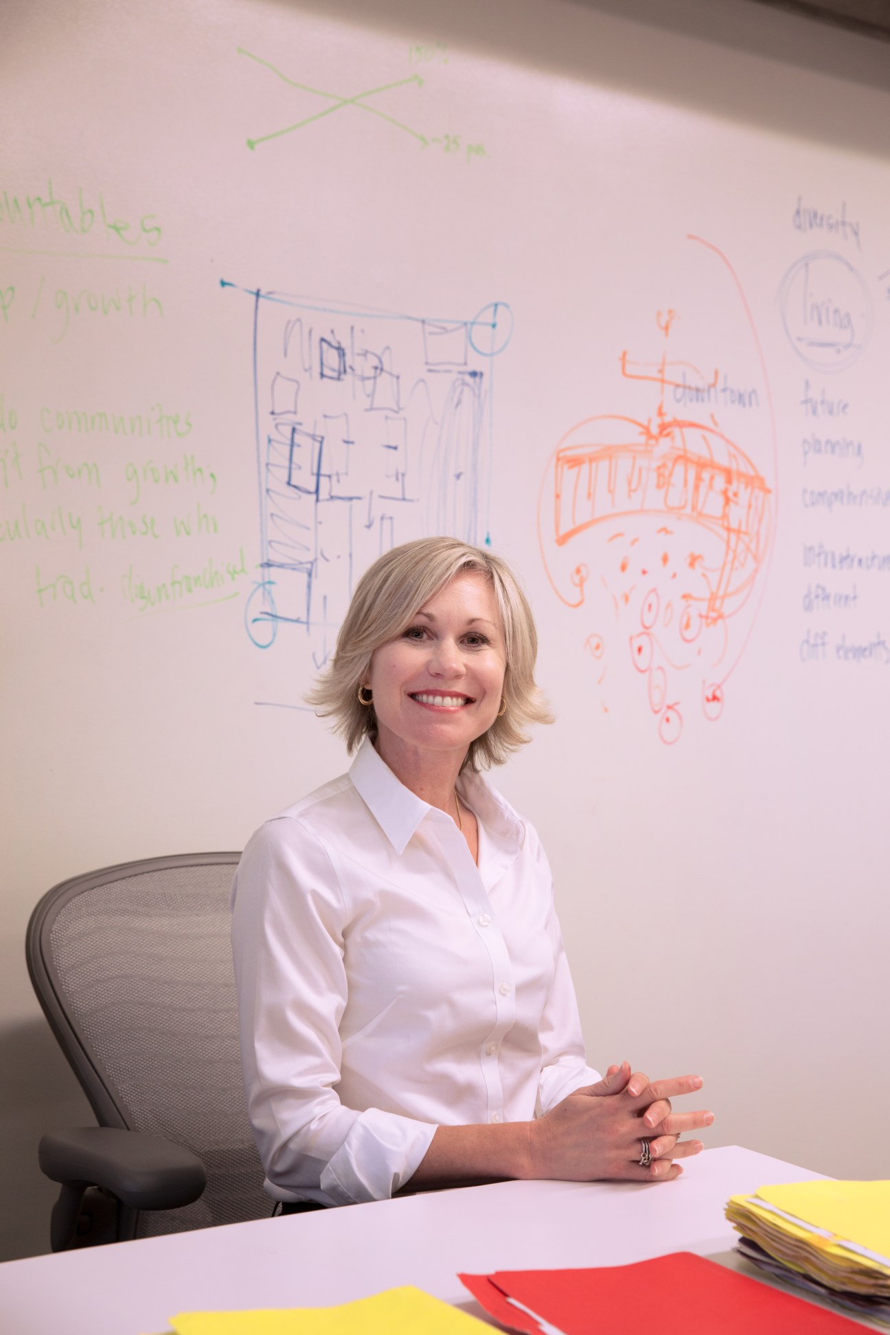Jennifer Keesmaat, Toronto's chief planner, sits at her desk in front of a whiteboard with architectural sketches and notes.