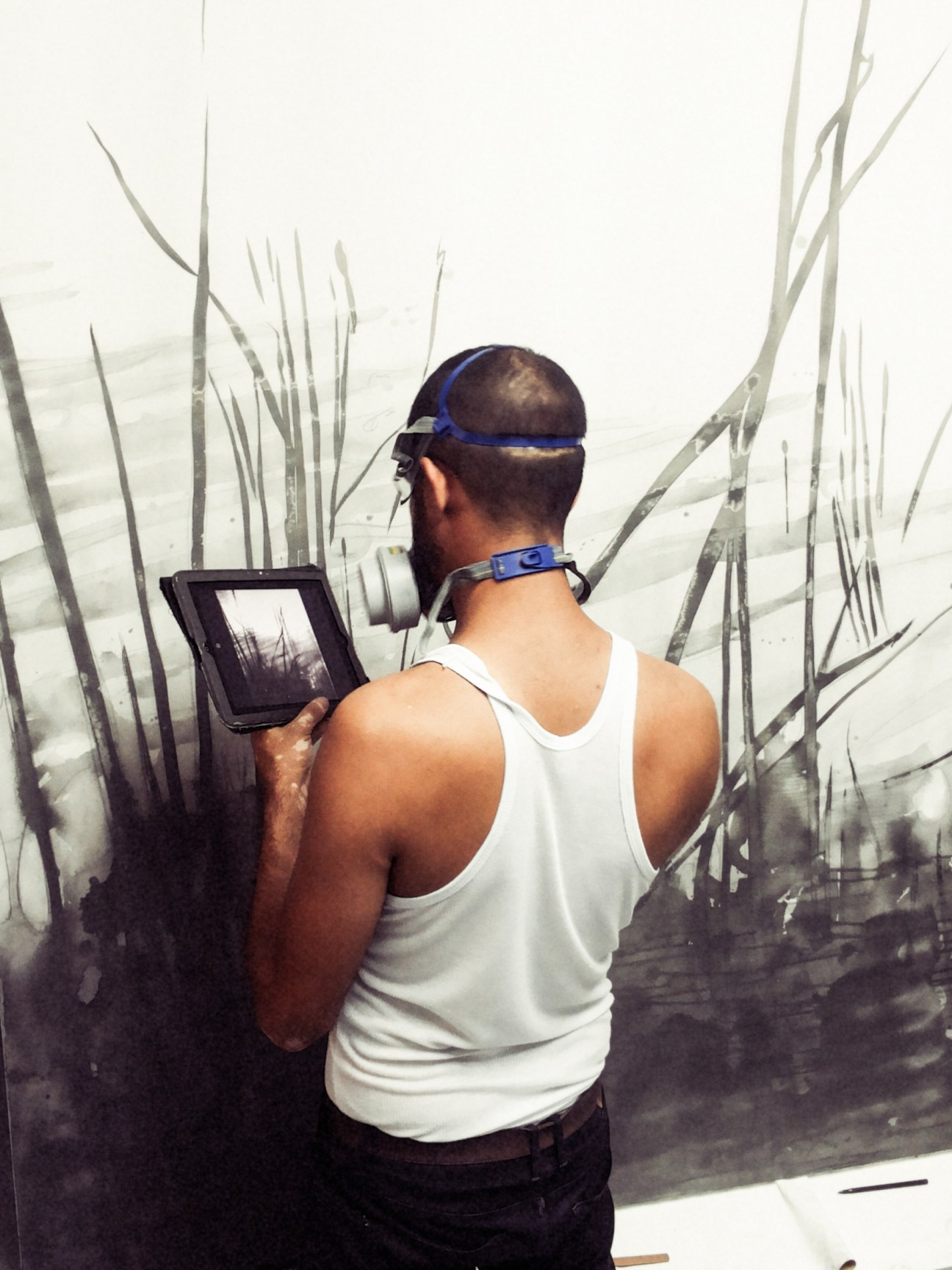Frank Mujica working on a large-format graphite drawing in his studio.
