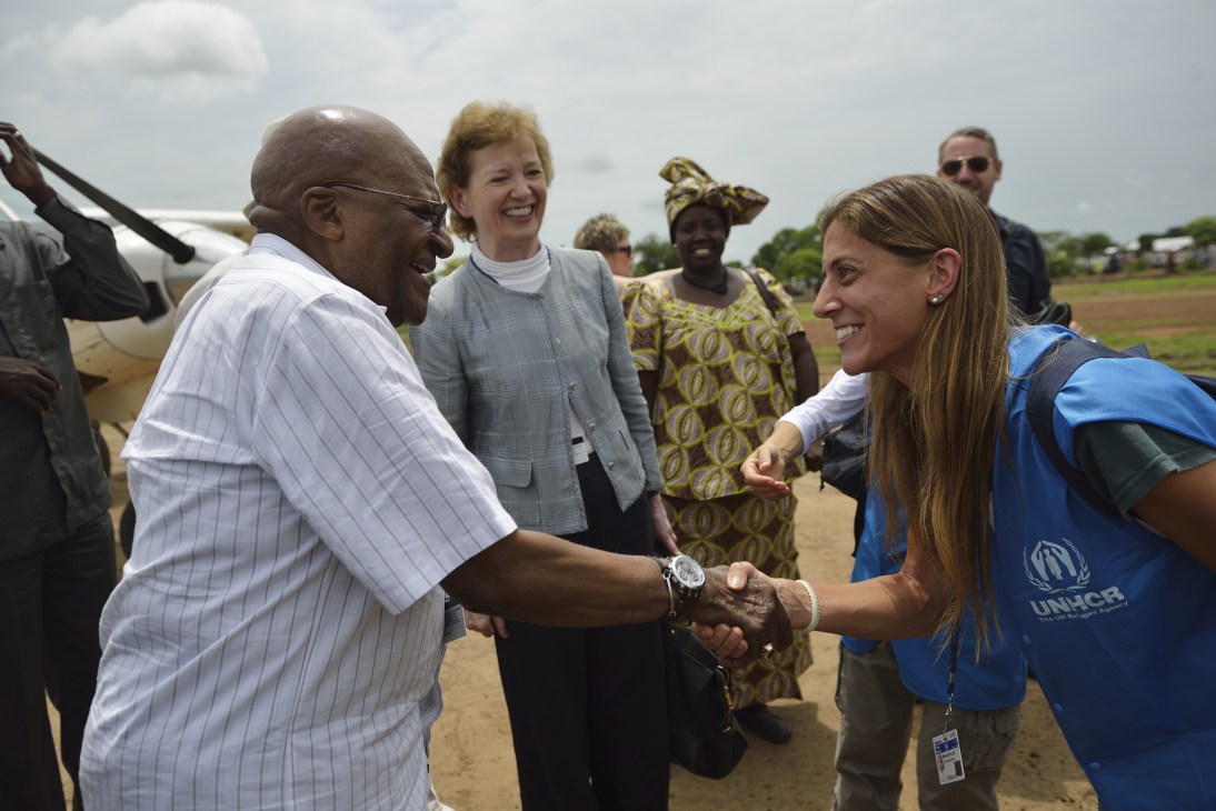 Desmond Tutu greets Maria Del Pilar of UNHCR at Doro airstrip in South Sudan.
