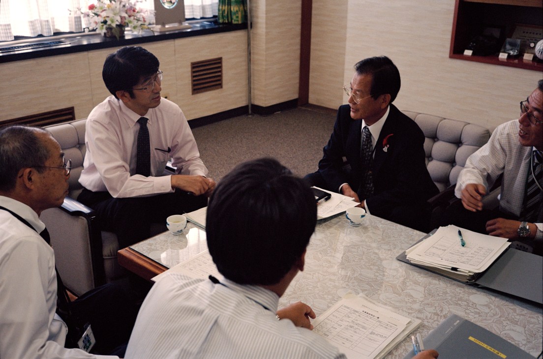 Tomihisa Taue, Mayor of Nagasaki, leads a Monday morning briefing with city officials in a conference room.