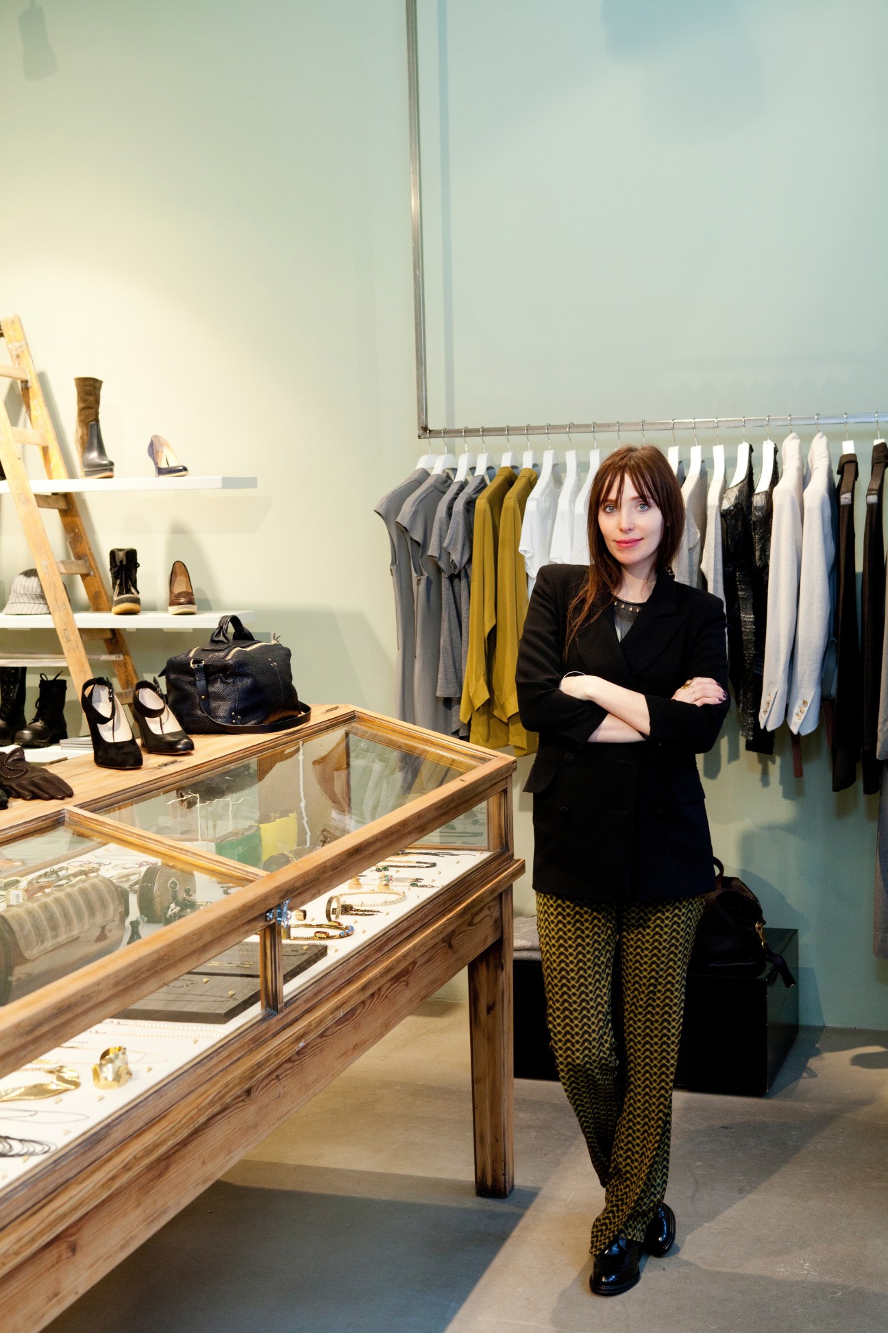 Cecilia Steiner stands in her Nitty Gritty boutique in Stockholm, surrounded by clothing racks and display cases.