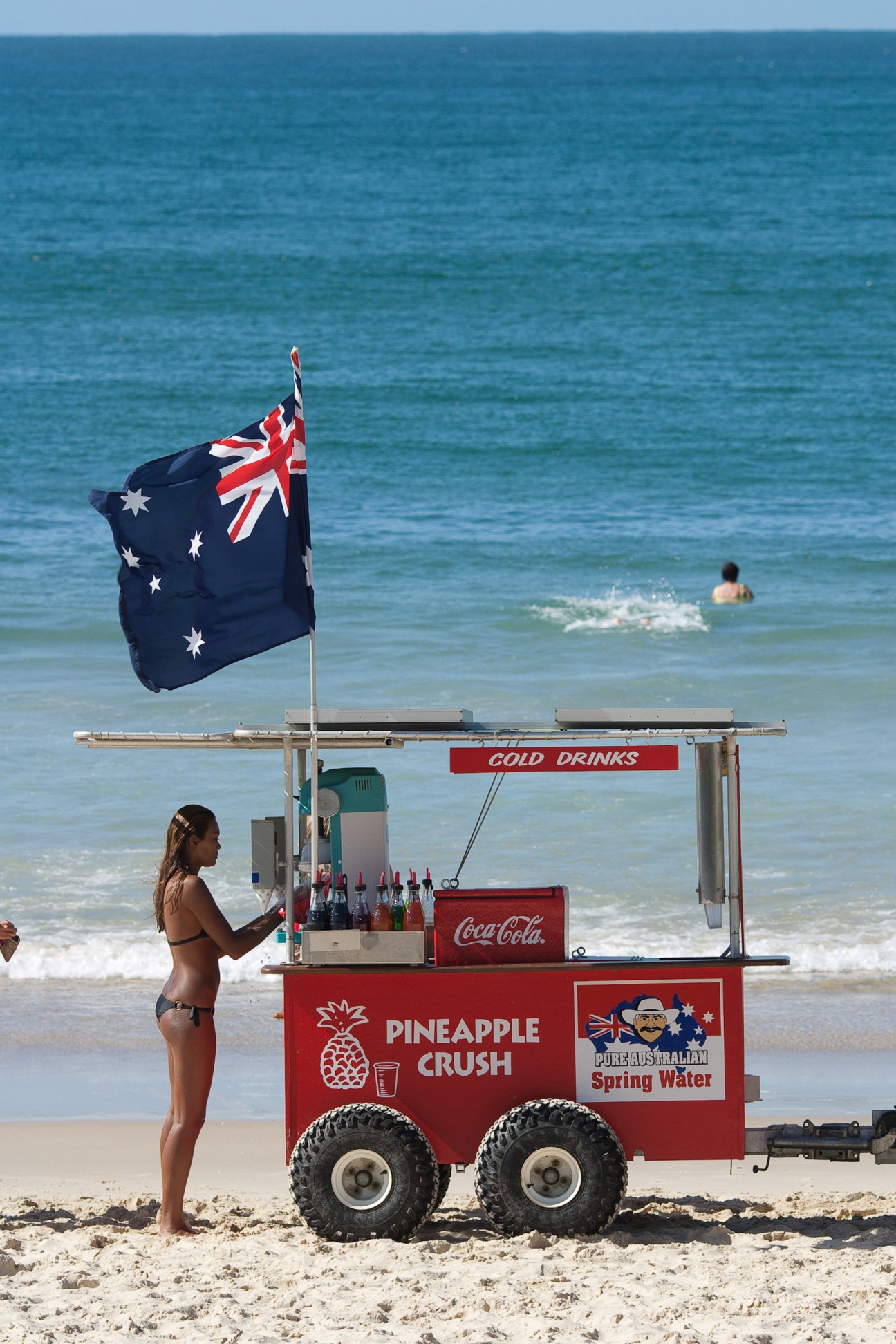 Beach vendor cart with Australian flag selling cold drinks at Noosa, Australia