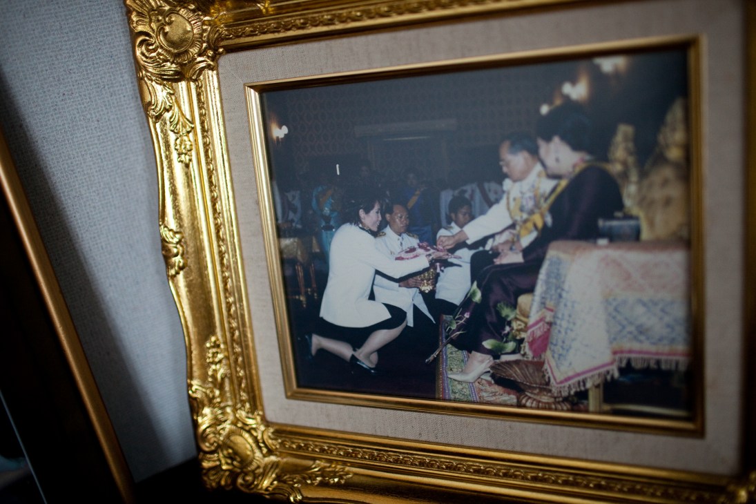 Framed photograph of Porntip Rojanasunan receiving an honor from the Thai King