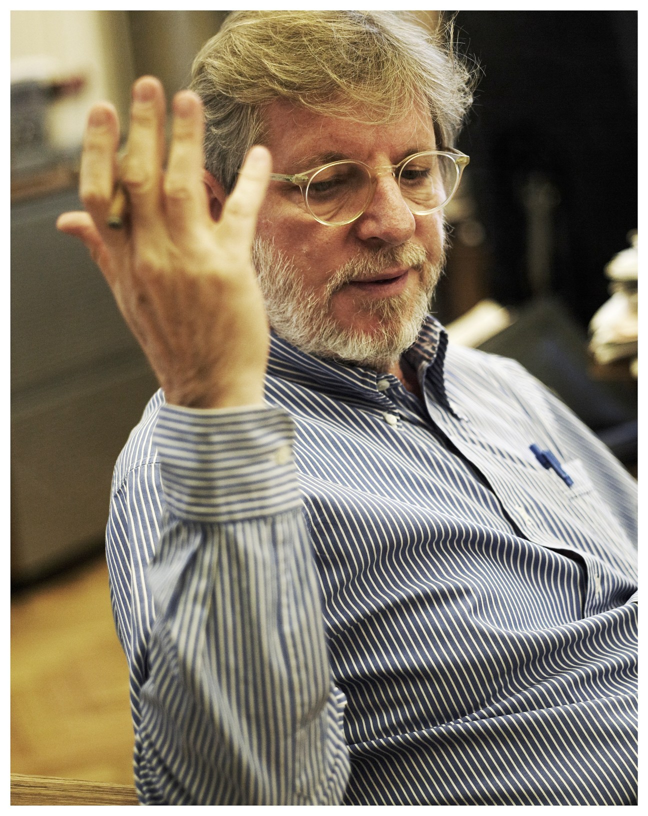 Oscar Bronner, Israeli-born founder of Der Standard newspaper, wearing glasses and a striped shirt.