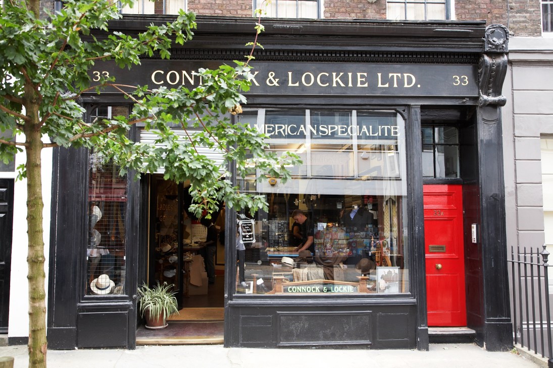Connock & Lockie tailor shop storefront with black facade and large windows on Lamb's Conduit Street.