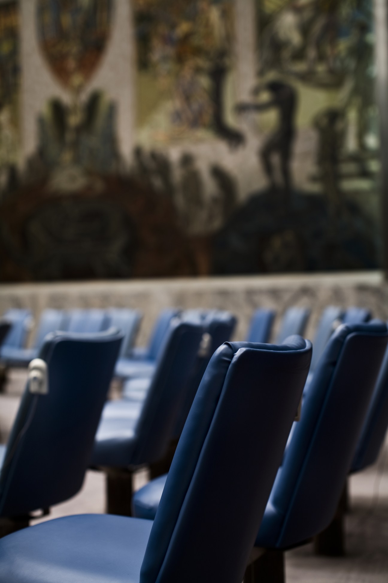 Blue upholstered chairs arranged in rows at the UN Security Council chamber.