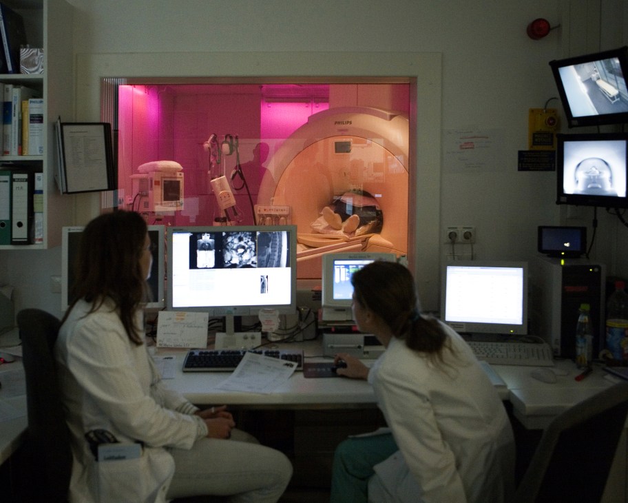 Two doctors monitor an MRI scan of a patient at Munich's Klinikum Rechts der Isar hospital.