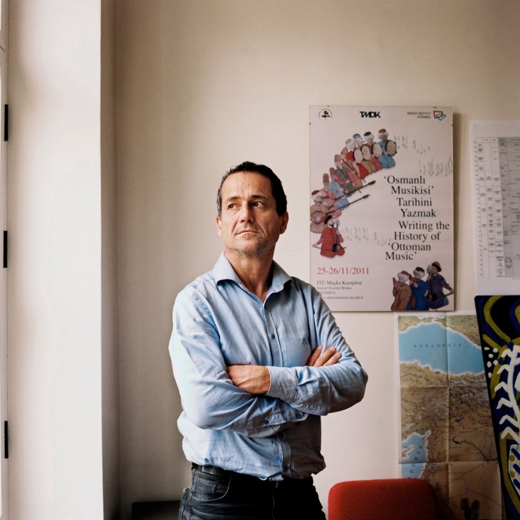 Jean-François Pérouse, director of the French Institute of Anatolian Studies, standing with arms crossed in his office.