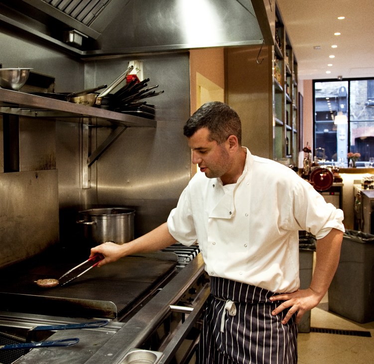 Chef Jacob Kenedy cooking at the grill in Bocca di Lupo's kitchen.