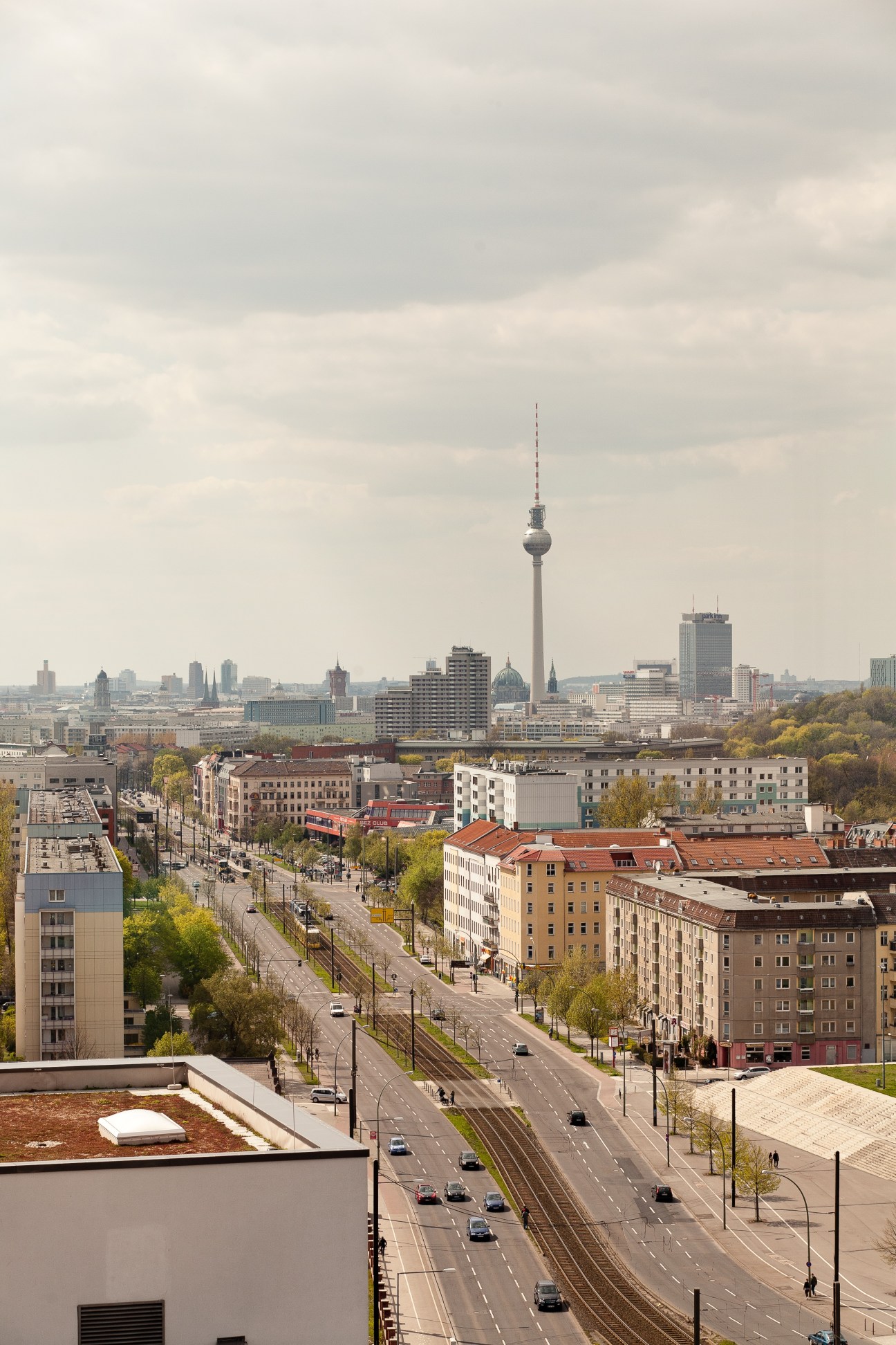 Panoramic view of Berlin showing the TV Tower, Alexanderplatz, and surrounding East German prefabricated apartment buildings.
